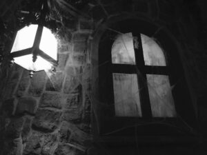 spooky window with lamp and spider web